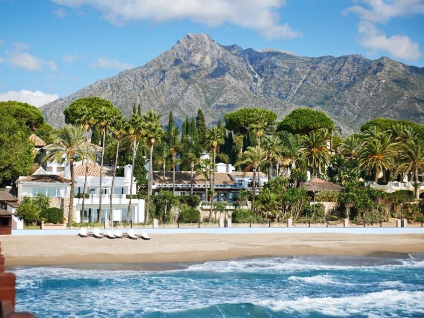 The Marbella Club Hotel, viewed from the pier — with La Concha mountain rising behind.